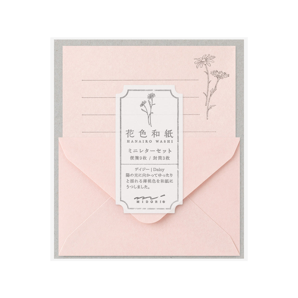 Pink stationery set with a label featuring floral designs and text on a white background