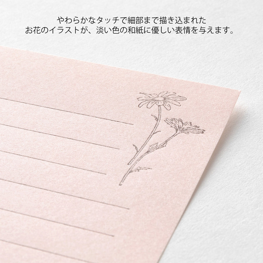 Pink stationery set with a label featuring floral designs and text on a white background